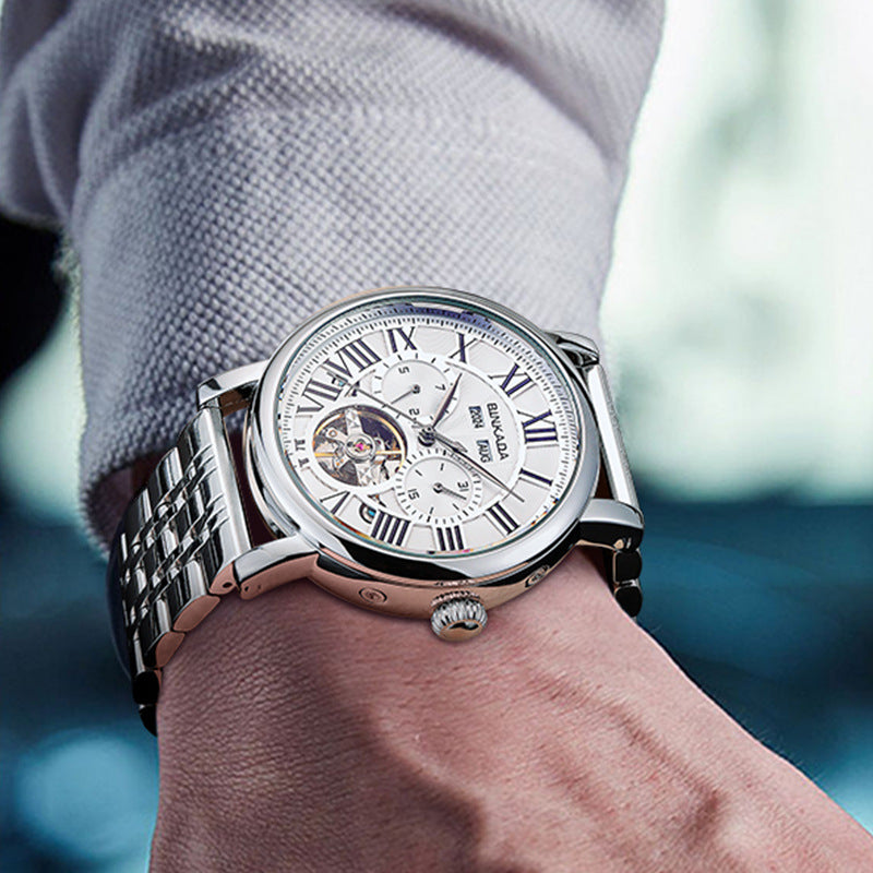 Men's automatic mechanical watch on wrist with silver steel bracelet and white dial