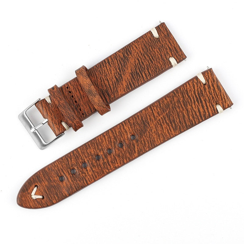 Orange-brown patterned leather watch strap with silver buckle and perforated adjustment holes