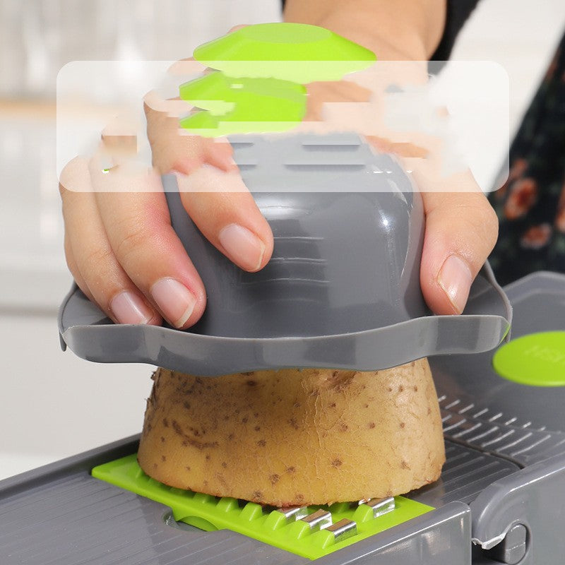 Vegetable slicer cutting a potato on a lime green platform