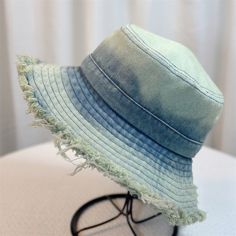 Light blue denim bucket hat with frayed edge and curved stitched panels