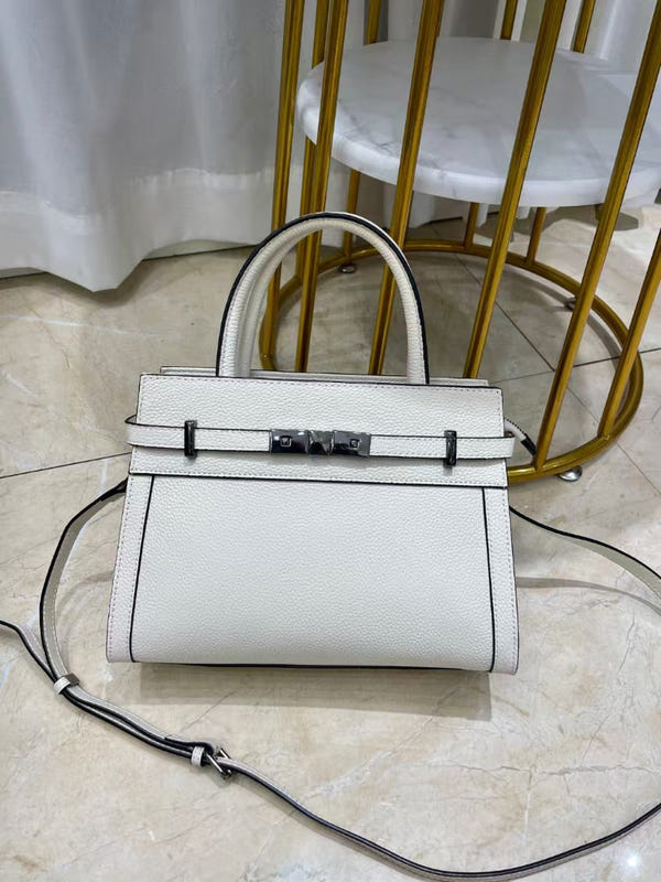 White small square leather shoulder bag with structured top handle and crossbody strap.