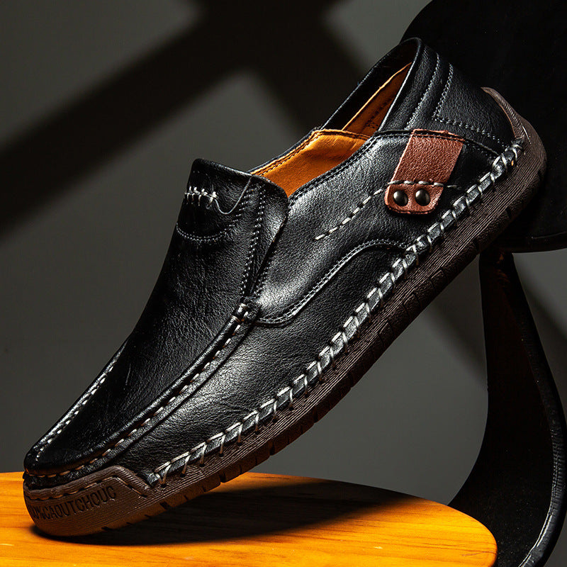 Black leather slip-on loafer with brown strap accent and contrast stitched trim