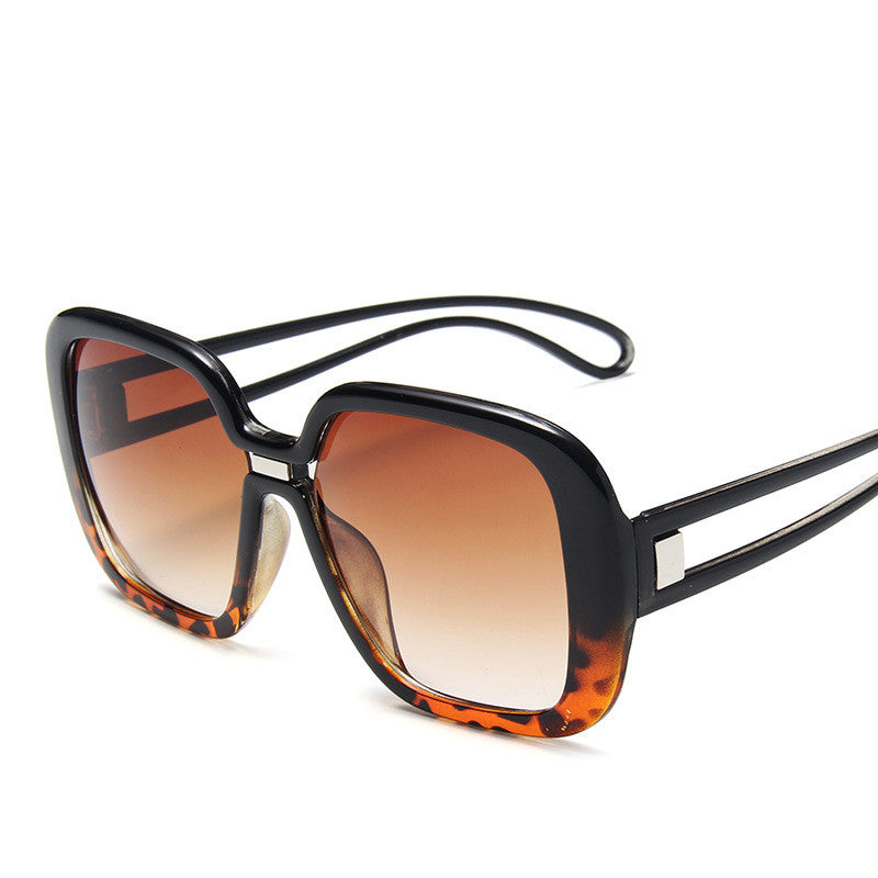 Large square sunglasses with dark frame and orange-to-amber gradient tinted lenses