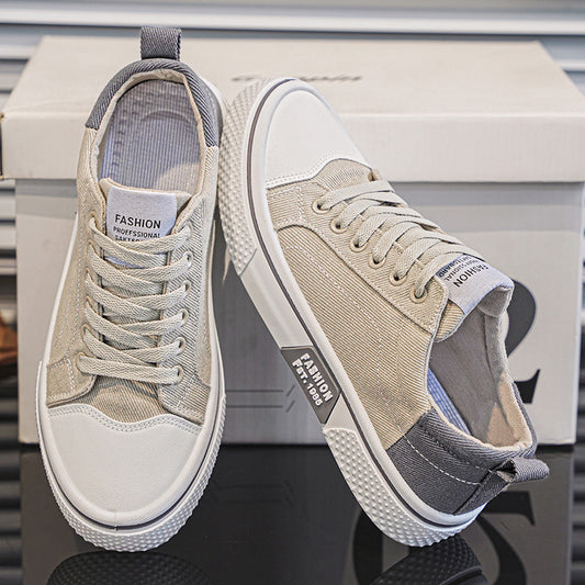 Pair of beige and white sneakers on a reflective surface with a blurred background