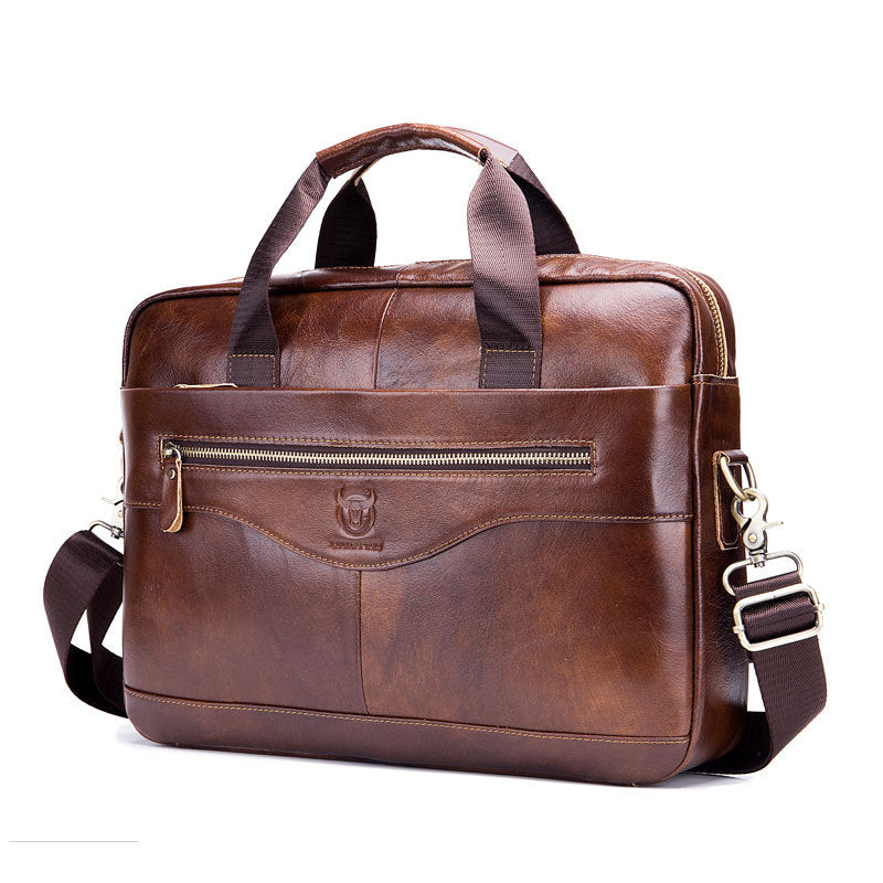 Brown leather briefcase, front view with zip closure, keyring, and shoulder strap