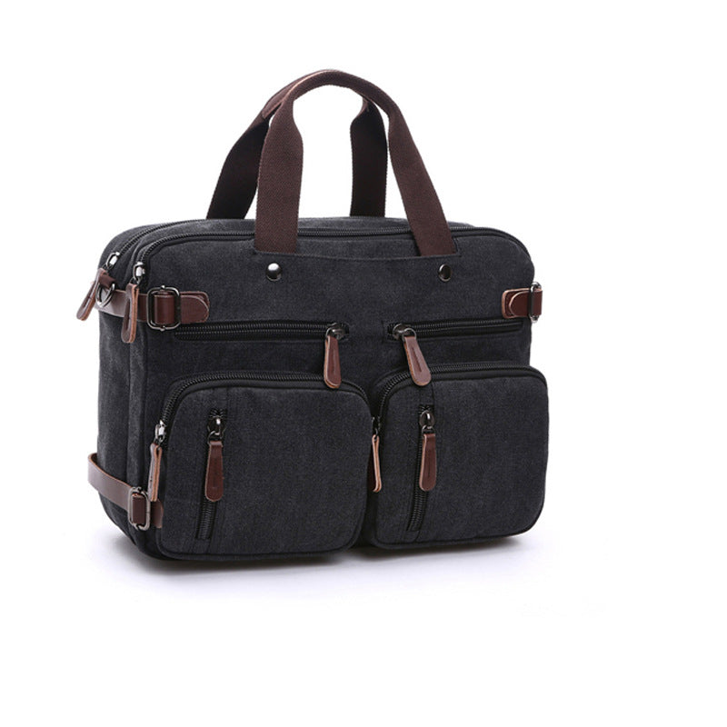 Black canvas bag with top handles, multiple front pockets, and adjustable shoulder strap