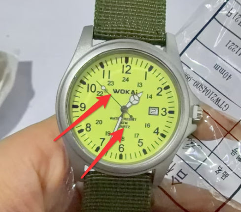 Quartz wristwatch with olive canvas strap and lime dial, close-up with date window at 3 o’clock.