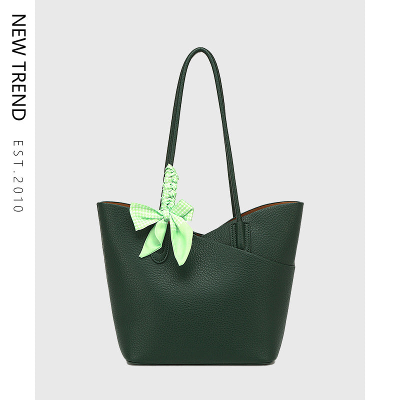 Green textured shoulder tote handbag with bright bow charm