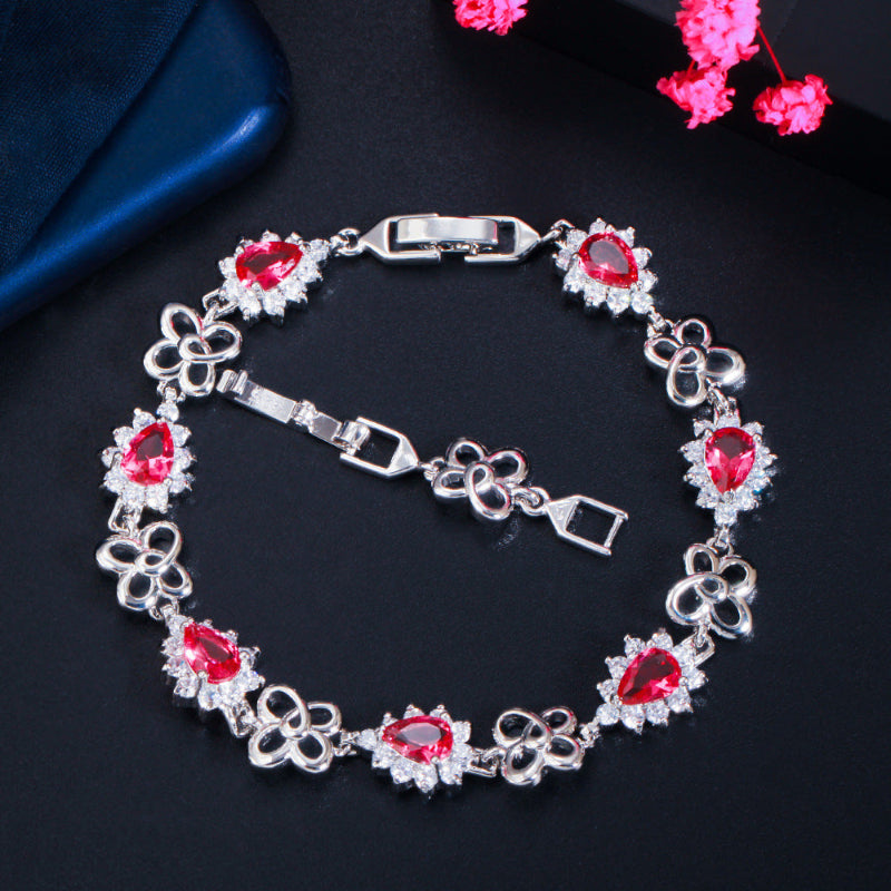18K gold-plated zircon bracelet with red gemstone links and hinged clasp