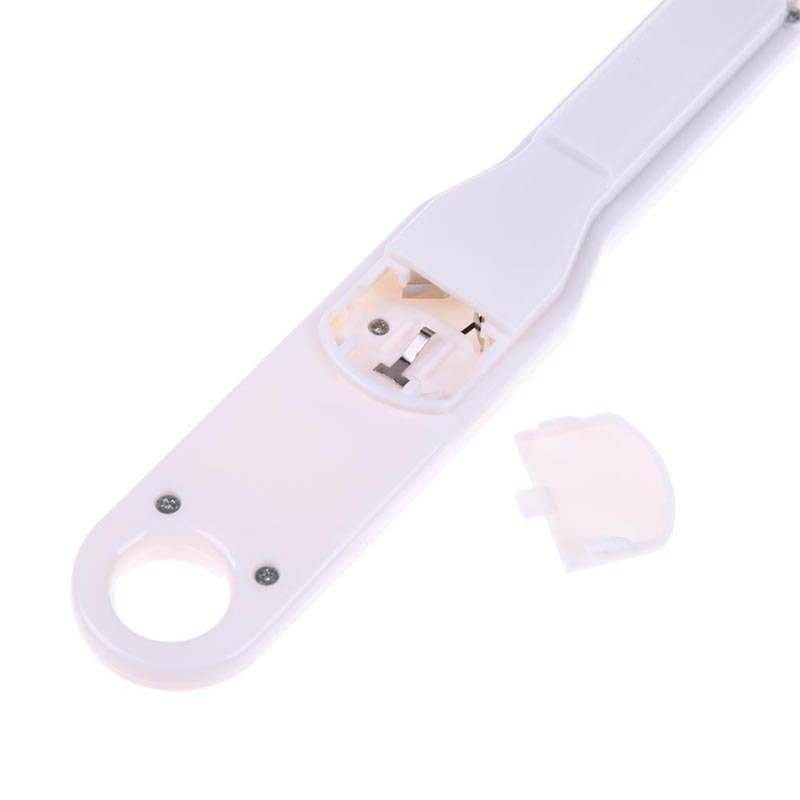 White kitchen scale spoon with open battery compartment on underside