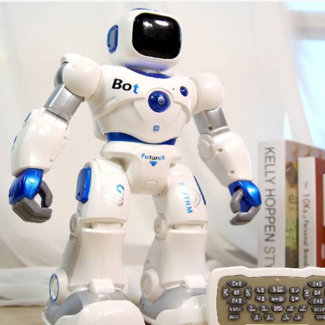 White robot toy with blue buttons and dark head screen, close-up front view