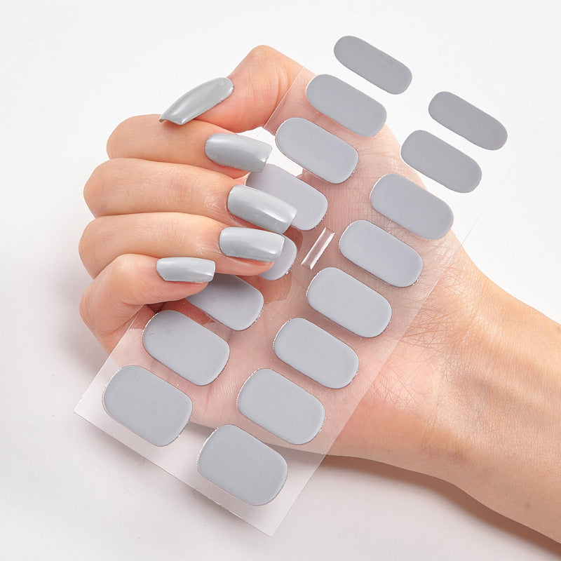 Nail sticker wraps on clear sheet with light gray solid nail decals