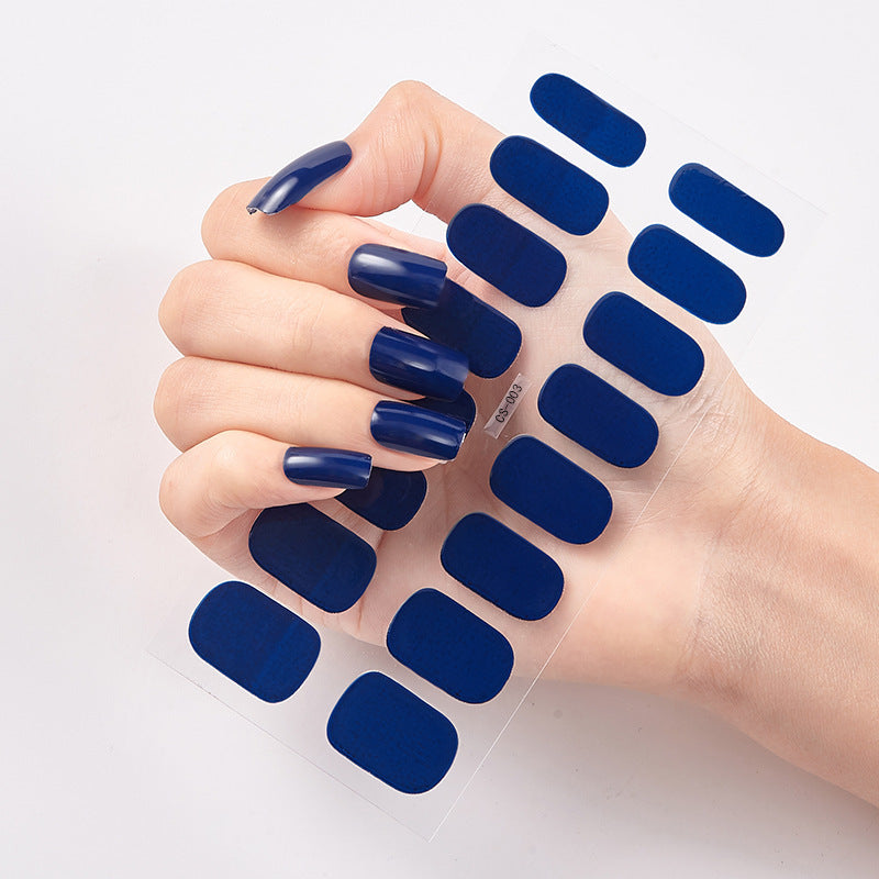 Nail sticker wraps with dark navy blue press-on style nails on clear sheet