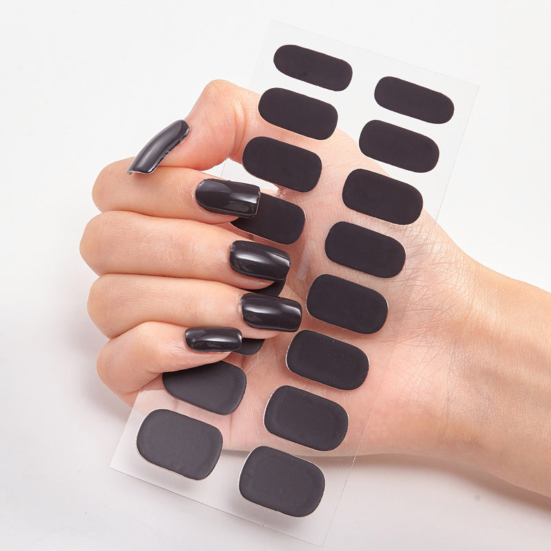 Nail sticker wraps on clear sheet with dark black solid nail decals
