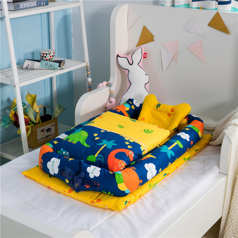 Portable baby nest with bright blue animal print mattress and layered bolster support