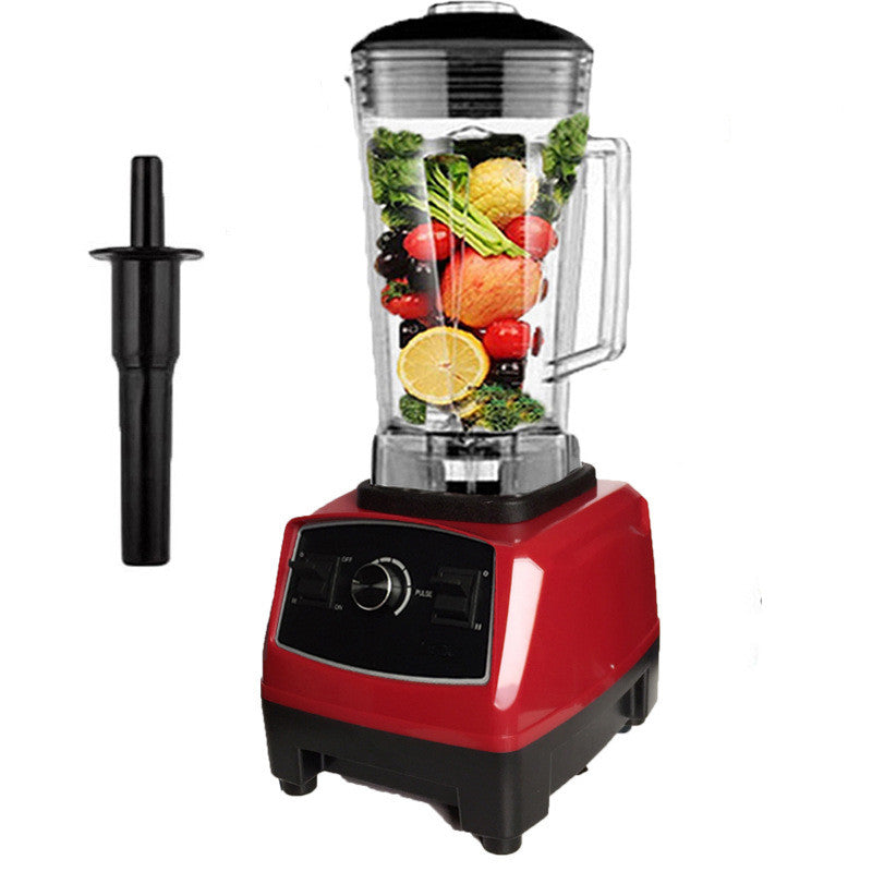 Red countertop blender with clear jar filled with mixed fruit and vegetables