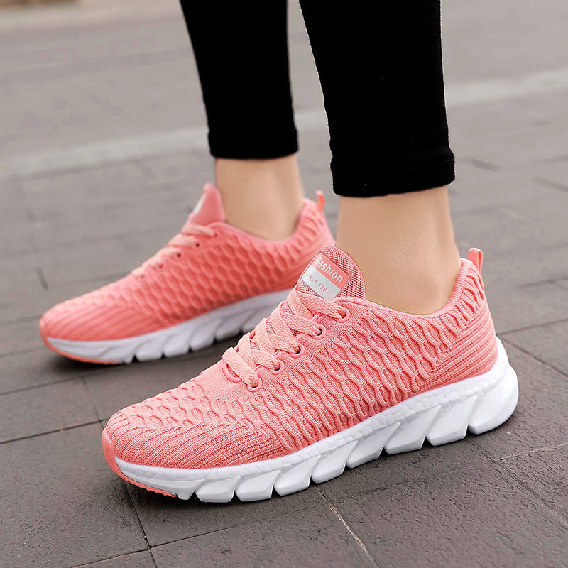 Light pink knit running shoes with laces and white cushioned sole