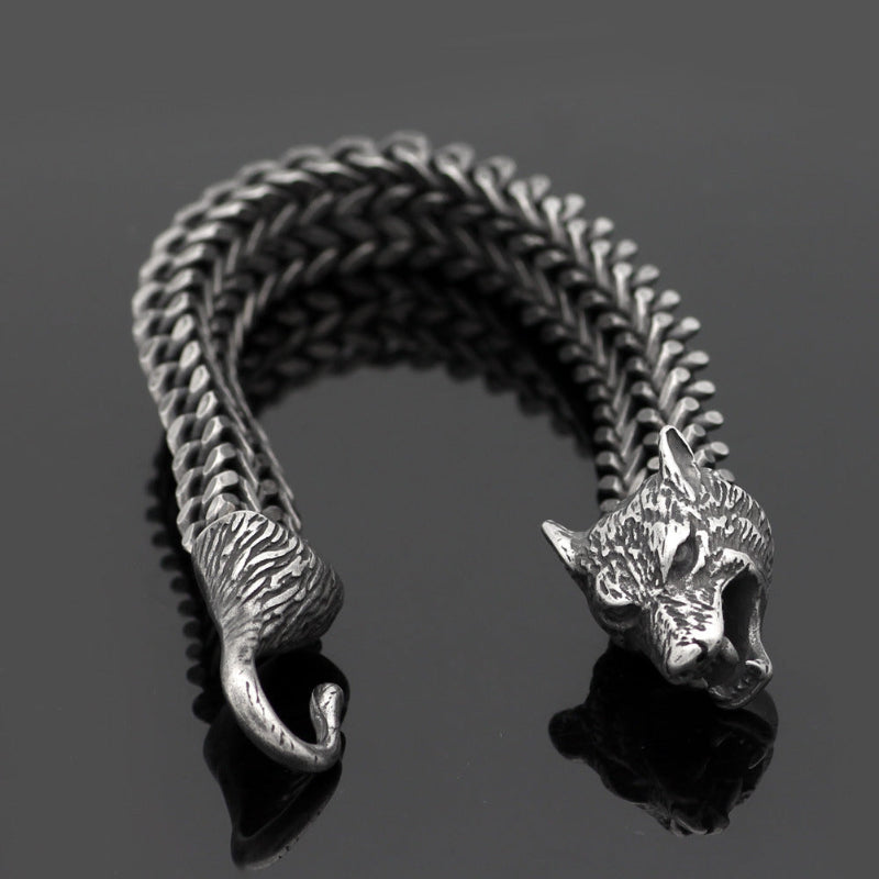 Close-up braided bracelet with silver animal-head end links on black chain