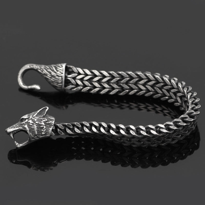 Black braided bracelet with silver animal-head charms and loop clasp