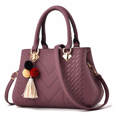 Women's crossbody handbag, purple PU leather with pom tassel charm and gold-tone hardware