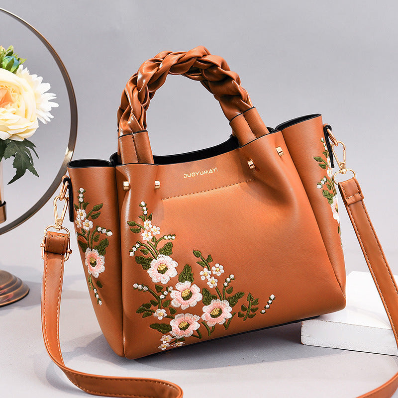 Floral PU handbag tote in orange with braided handles and long crossbody strap