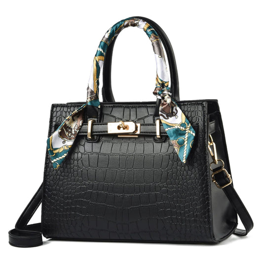 Black crocodile-patterned handbag with a decorative scarf on a white background