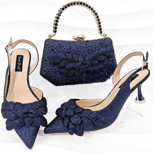 Navy blue glittery high-heeled shoes with matching handbag on a white background
