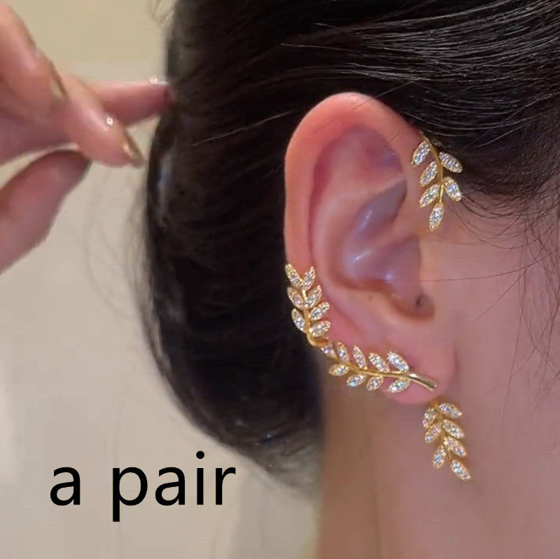 Gold leaf zircon stud earrings with ear-crawler and dangling charm