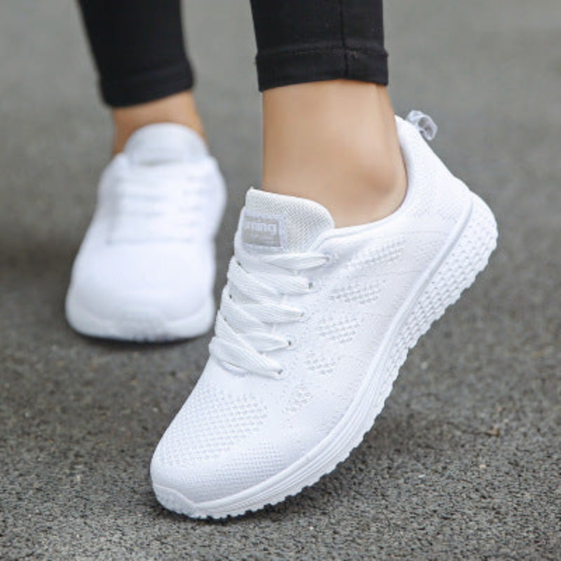 Women’s mesh sneakers, white upper with white rubber outsole worn with light pants