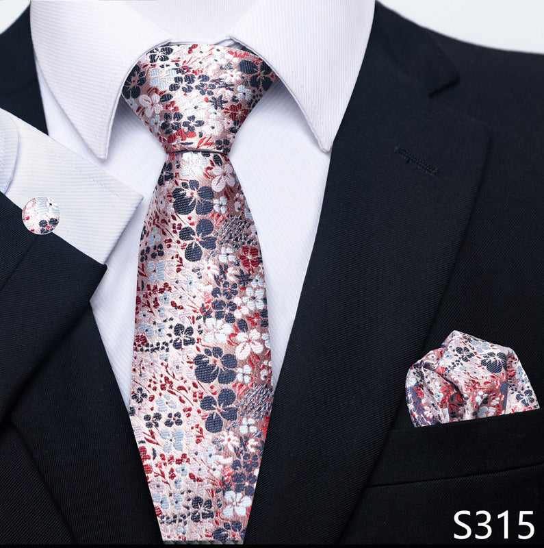 White tie with red and navy floral pattern set with matching pocket square and cuff links.