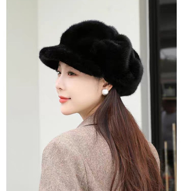 Black faux fur hat with rounded crown and wide brim; pearl stud earring