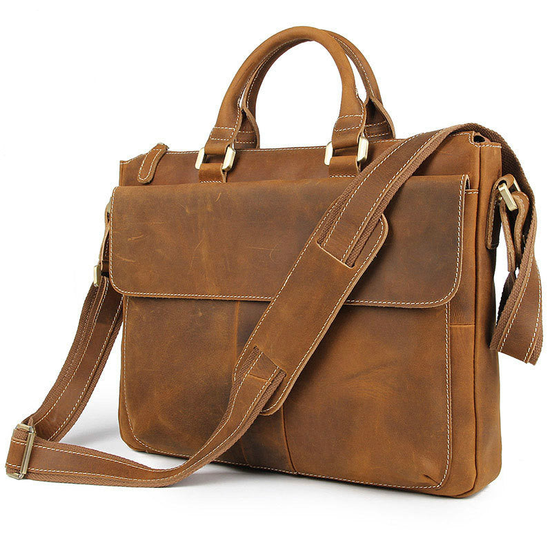 Tan leather crossbody bag with shoulder strap, front flap, and metal buckles.