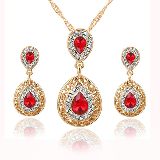 Gold-tone jewelry set: red teardrop pendant necklace with matching drop earrings