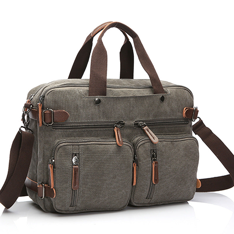Gray canvas bag with top handles, front zip pockets, and adjustable crossbody strap