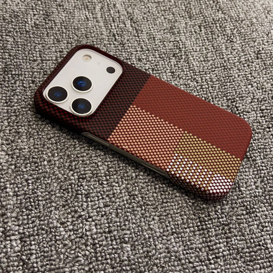 Phone case with brown and gold pattern on a textured surface