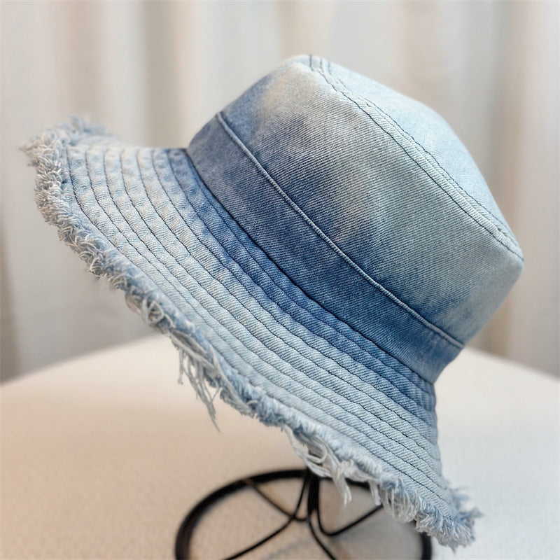 Light blue denim bucket hat with frayed wide brim and stitched crown panels