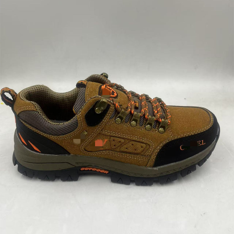 Tan hiking shoe with orange laces, mesh collar, side patch, rugged traction outsole