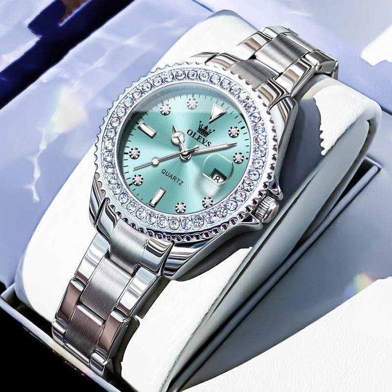 Quartz wristwatch with light green dial, crystal bezel, and silver metal link bracelet