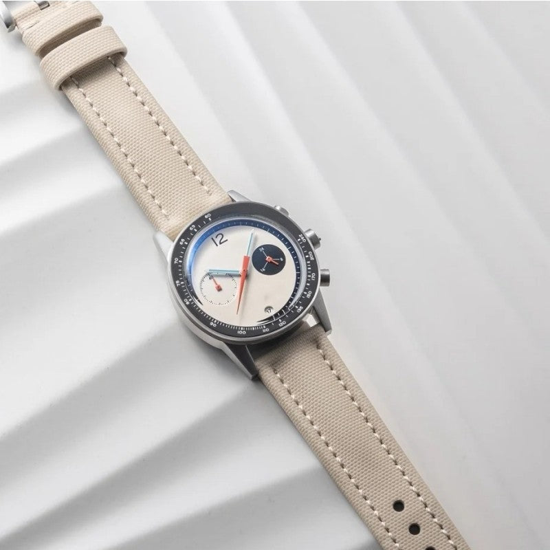 Beige strap quartz wristwatch, round dark case with white dial and three subdials