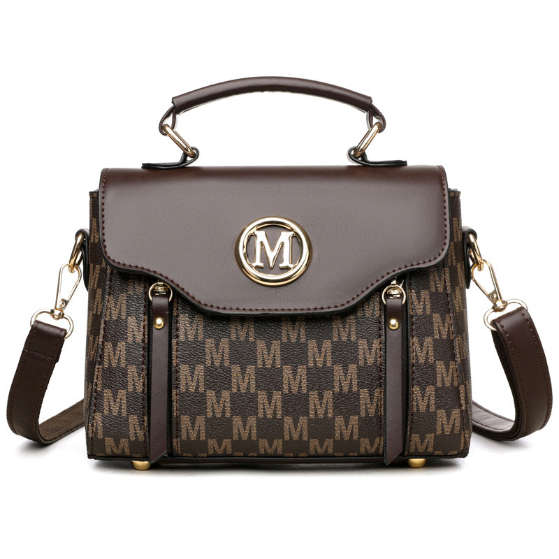 Brown monogram crossbody handbag with flap top, gold M emblem, dual side pockets