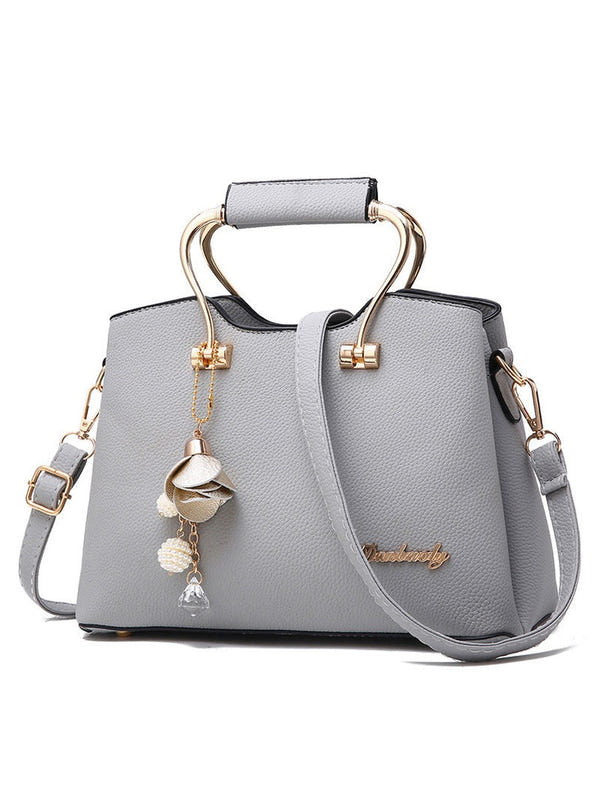 Gray textured handbag with top handle and crossbody strap, gold-tone lock and dangling charm