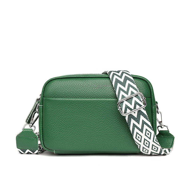 Green faux leather crossbody bag with chevron strap, zip closure, and metal clasp