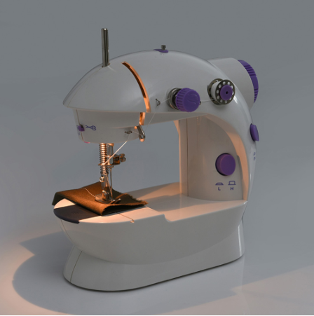 Mini sewing machine with dome top, purple knobs, and needle over fabric