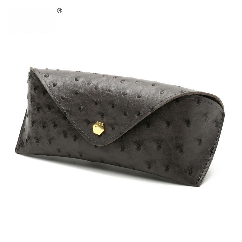 Gray polka dot leather sunglasses case with curved flap and gold-tone clasp