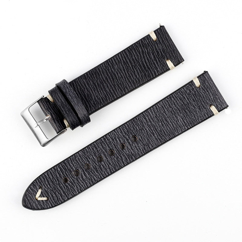 Black patterned leather watch strap with silver buckle and perforated adjustment holes