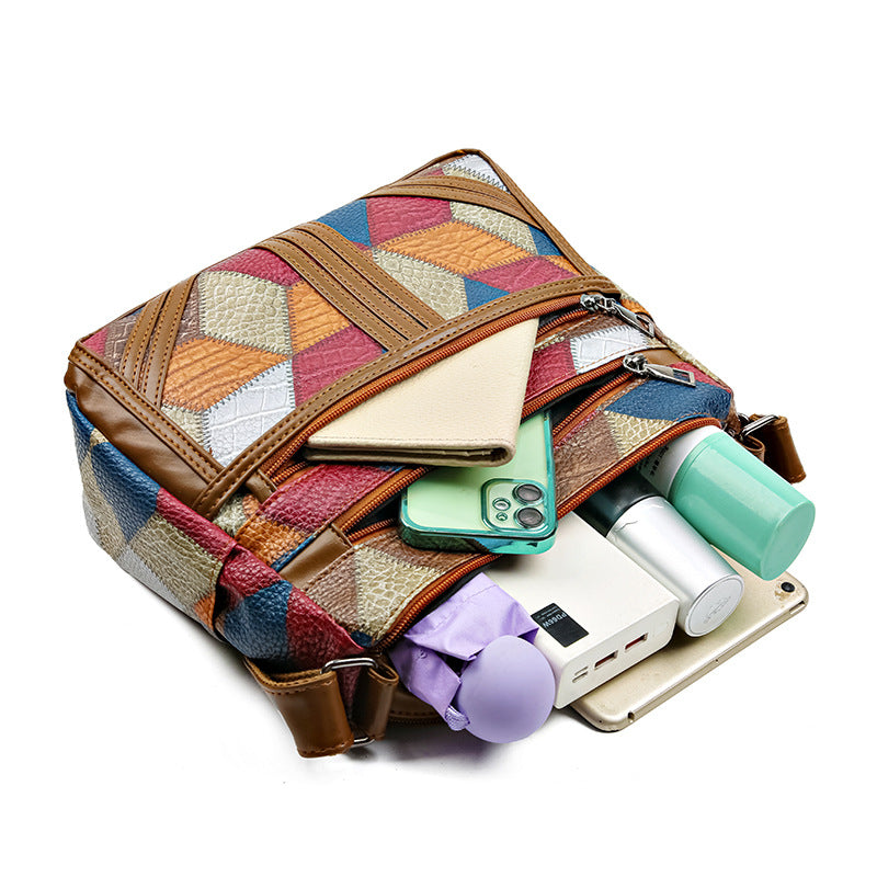 Patchwork crossbody bag open top showing card slot, phone and small items in pockets