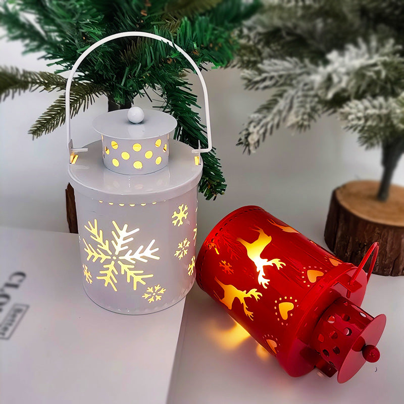 White LED lantern candle with snowflake cutouts and glowing red lantern with handle
