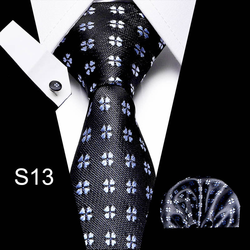 Business tie in black with light motif pattern and matching pocket square.