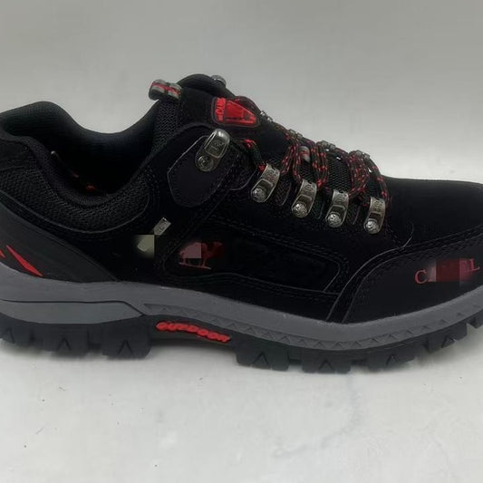 Black hiking shoe with red accents on a white background