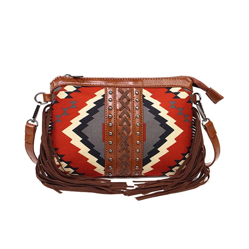 Multicolor patterned crossbody bag with studded center strip and fringe tassel detailing